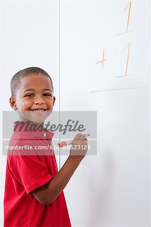 Boy with sum on whiteboard