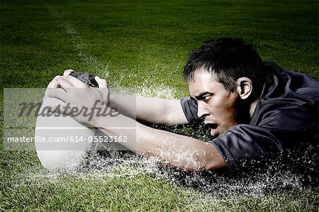 Rugby player on wet field