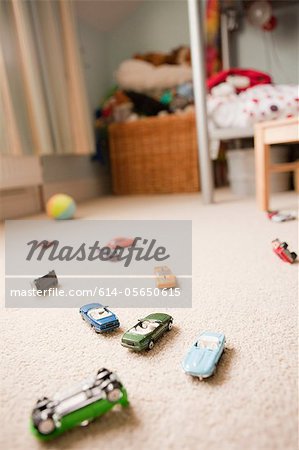 Toy cars scattered across a child's bedroom