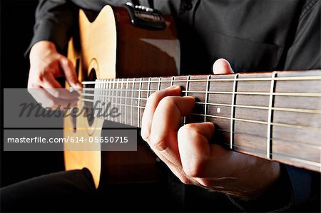 Close up of person playing classical guitar