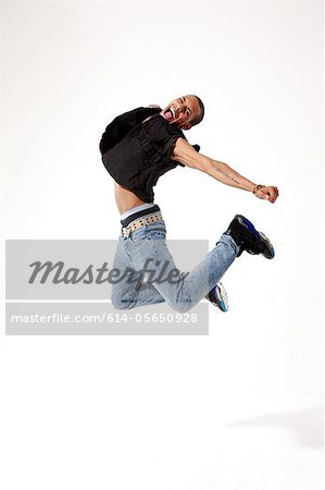 Jubilant young man in mid air