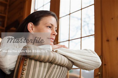Mature woman relaxing in armchair