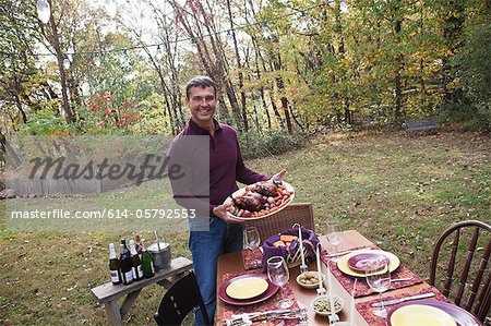 Mature man with food for outdoor dinner