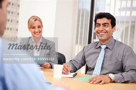 Business executives smiling in a meeting