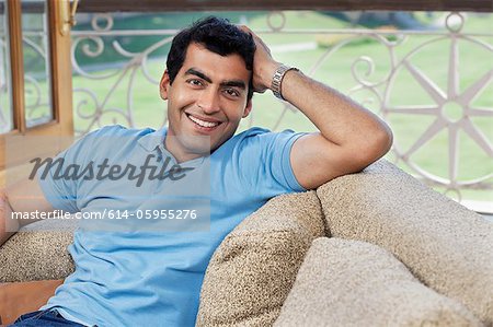 Portrait of a man sitting on a sofa