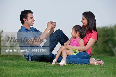 Man taking a photograph of his family