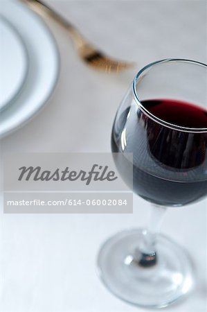 Glass of red wine on table