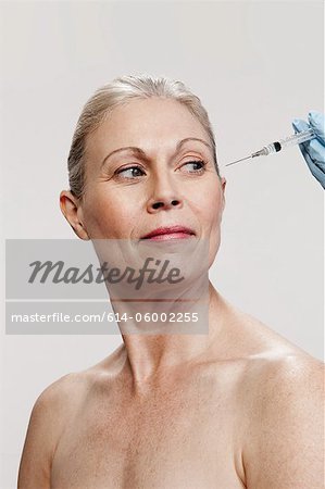 Mature woman receiving injections