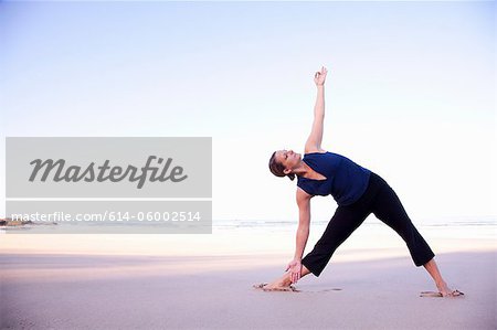 Woman doing yoga on beach, Playa Grande, Santa Cruz, Costa Rica