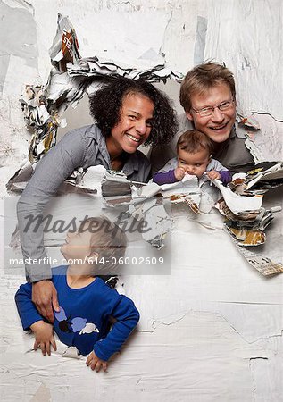 Happy family busting through a wall