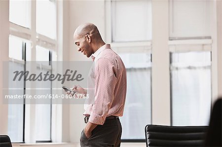 Businessman texting on cell phone