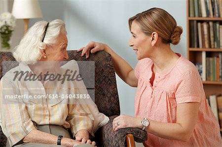 Daughter visiting senior mother in care home