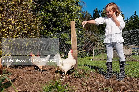 Girl feeding chickens