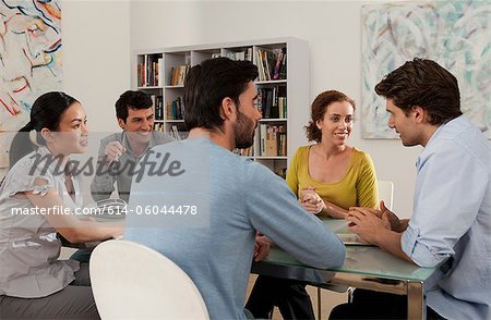 Men and women in discussion in gallery