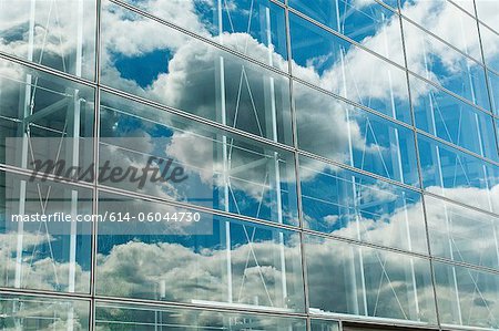 Cloudy blue sky reflected in office windows
