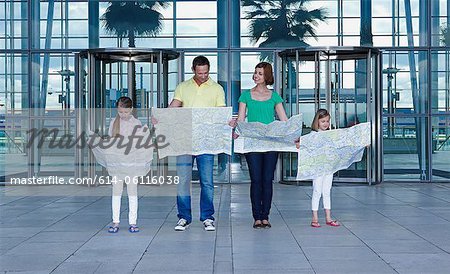 Family with maps outside airport