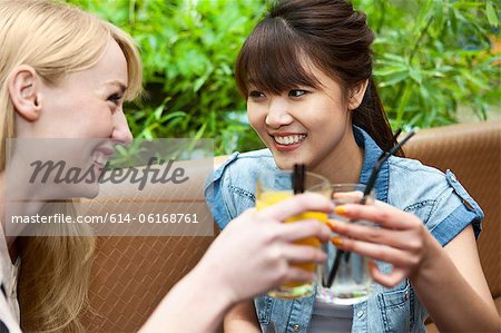 Female friends toasting with soft drinks