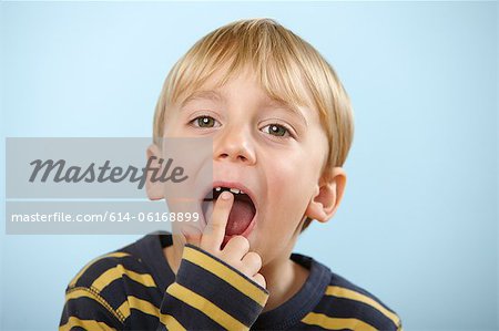 Boy pointing to gap in teeth
