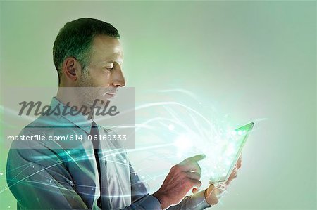 Businessman using digital tablet with lights Businessman using digital tablet with lights