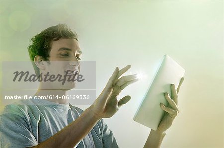 Young man using digital tablet with lights