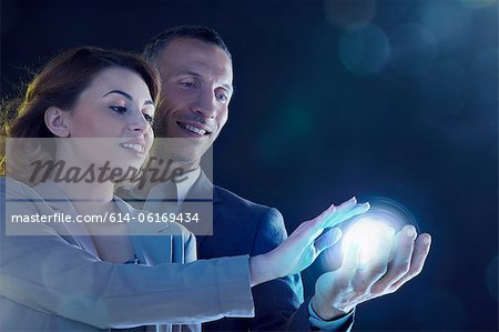 Businesspeople holding light