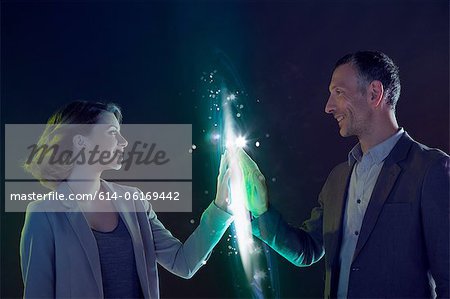 Businesspeople connecting through light Businesspeople connecting through light