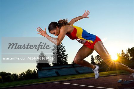 Female athlete leaving starting blocks