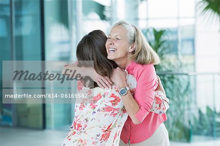 Adult mother and daughter embracing