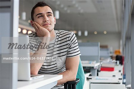 Man daydreaming at desk