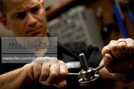 Man tightening bolt