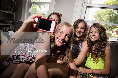 Group of girls being photographed with camera phone