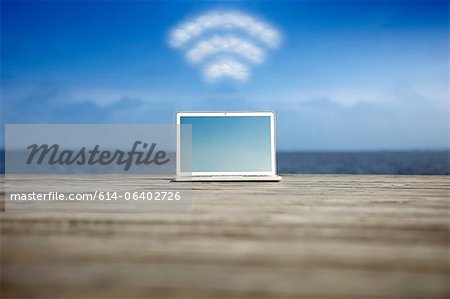 Laptop with wifi symbol at the coast Laptop with wifi symbol at the coast