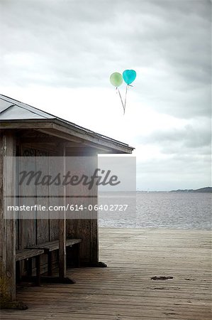 Balloons floating by old seaside shelter, Flensburg, Germany