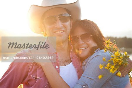 Happy couple in sunlight with flowers