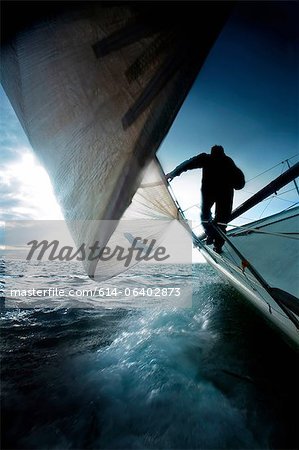 Silhouette of man on sailing boat Silhouette of man on sailing boat