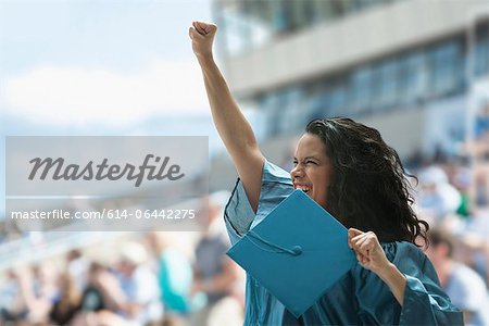 Female graduate raising fist