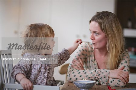 Daughter spoon feeding mother