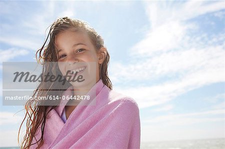 Girl with wet hair, wrapped in towel