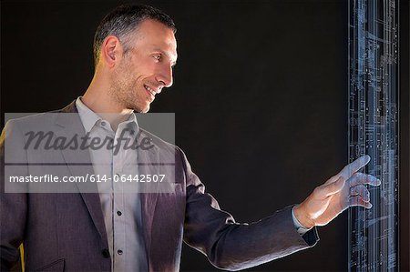 Businessman touching virtual information Businessman touching virtual information