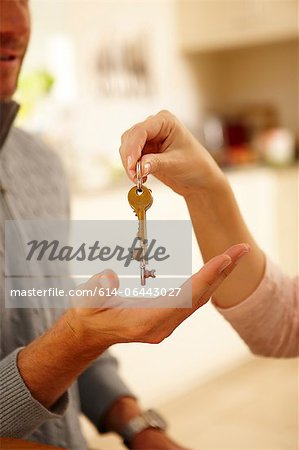 Woman giving man house key Woman giving man house key