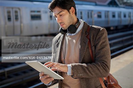 Man using tablet computer at station Man using tablet computer at station