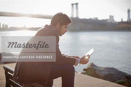 Man using tablet computer outdoors Man using tablet computer outdoors