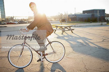Man riding bicycle on city street Man riding bicycle on city street