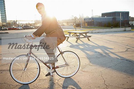 Man riding bicycle on city street