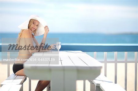 Woman sitting at table on deck