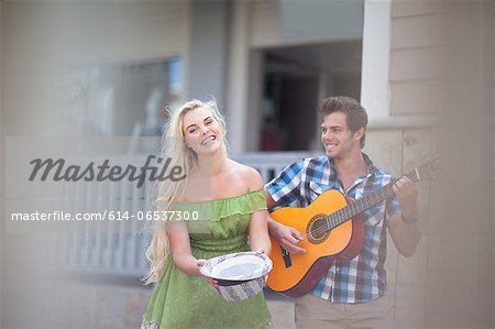 Couple playing music on street