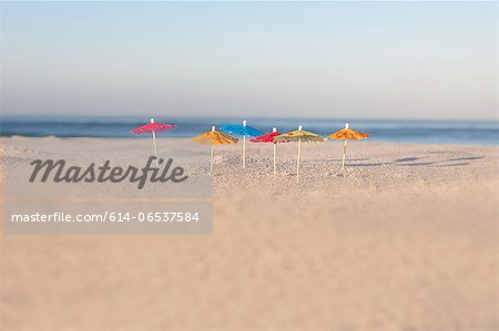 Drink umbrellas on empty beach