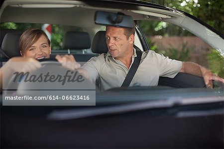Father teaching teenage daughter driving