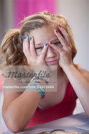 Frustrated girl with head in hands