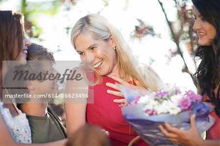 Family smiling at mother